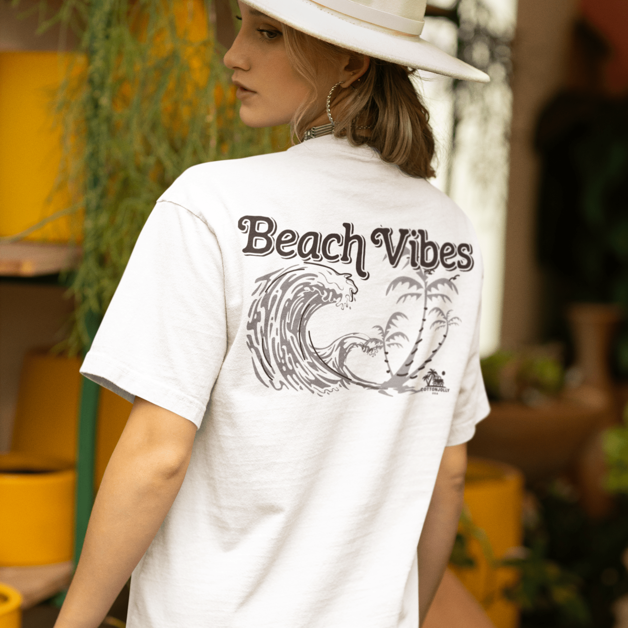 A women’s Beach Vibes Tee laid flat; made from 100% premium cotton, this ultra-soft, breathable t-shirt features a coastal-inspired design with gentle ocean waves, capturing the essence of beachside relaxation and carefree summer style.